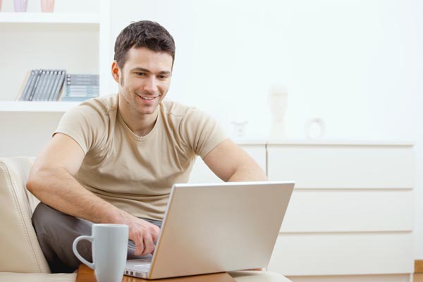 Happy man using computer