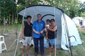 ShelterBox volunteer Sue Nelson with recipients of one of the non-profit's tent and recovery kit packages. Image courtesy ShelterBoxUSA.