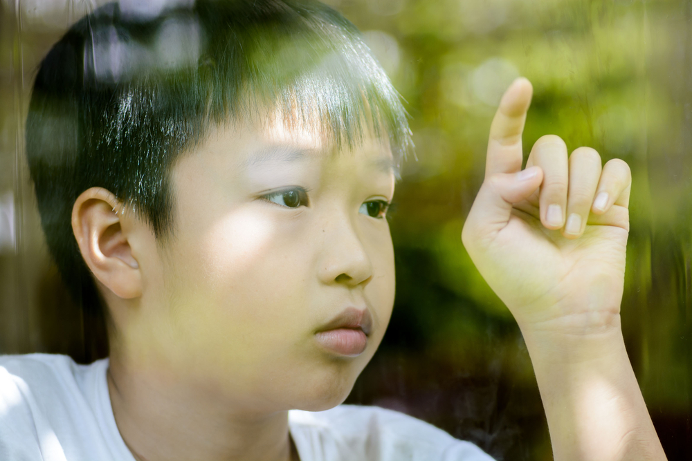 boy looking out of window