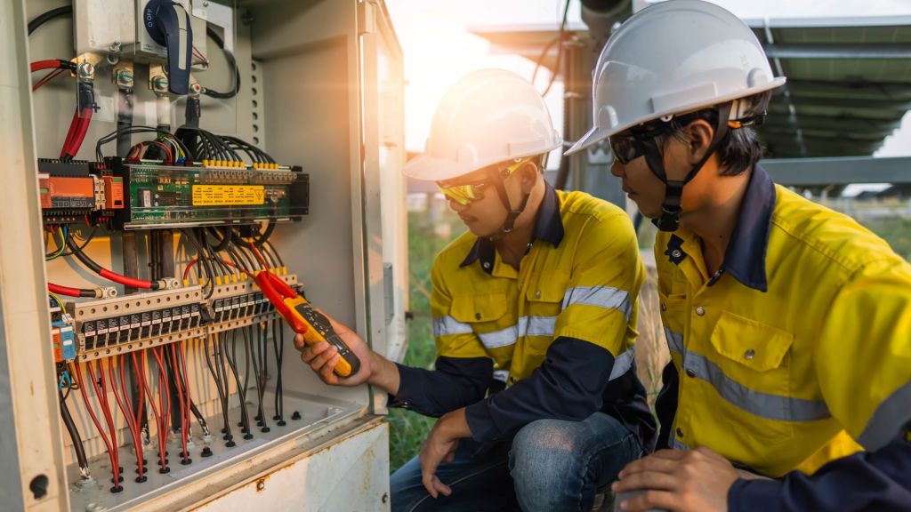 two men read energy meter to improve operational efficiencies