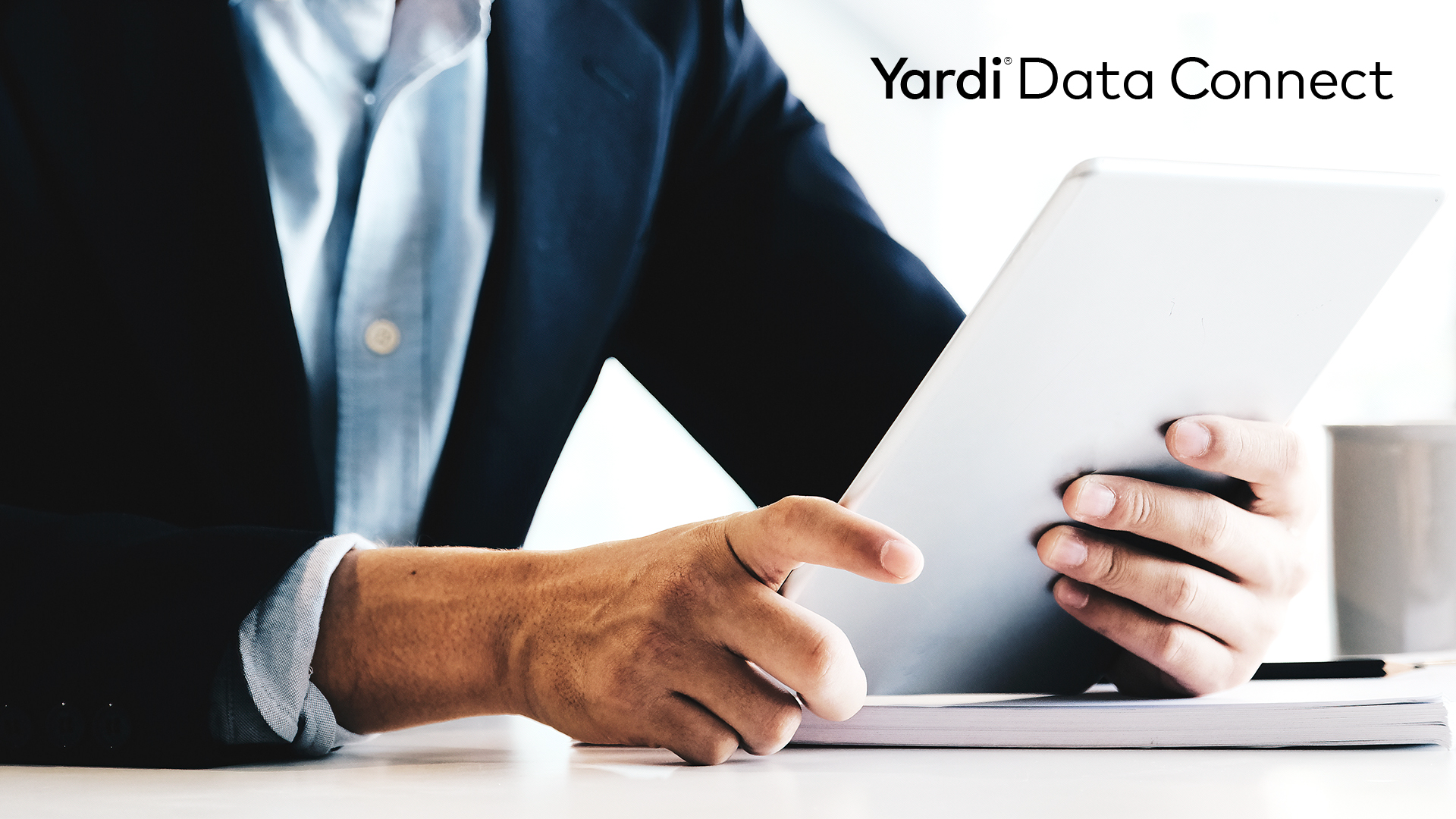 Text: "Yardi Data Connect," with image of person holding piece of paper