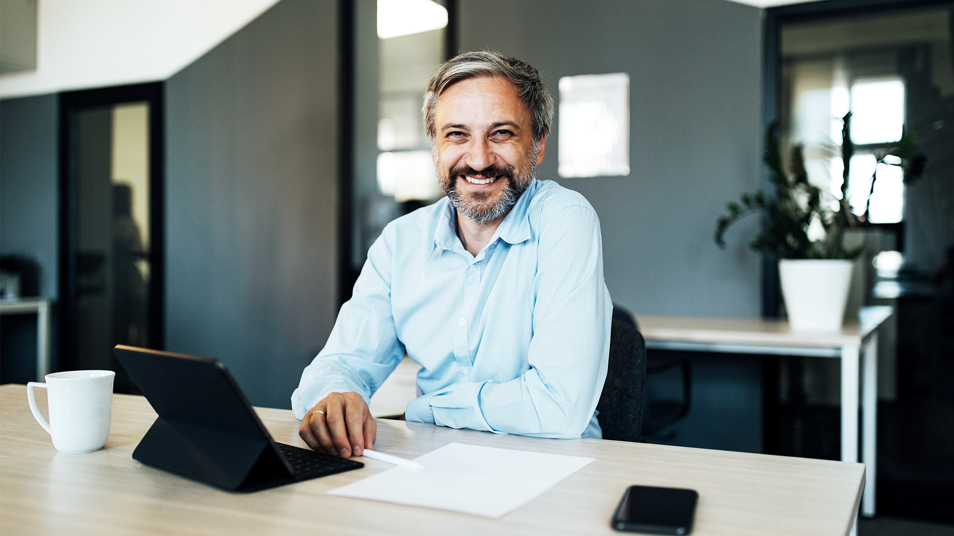 Man smiling at desk