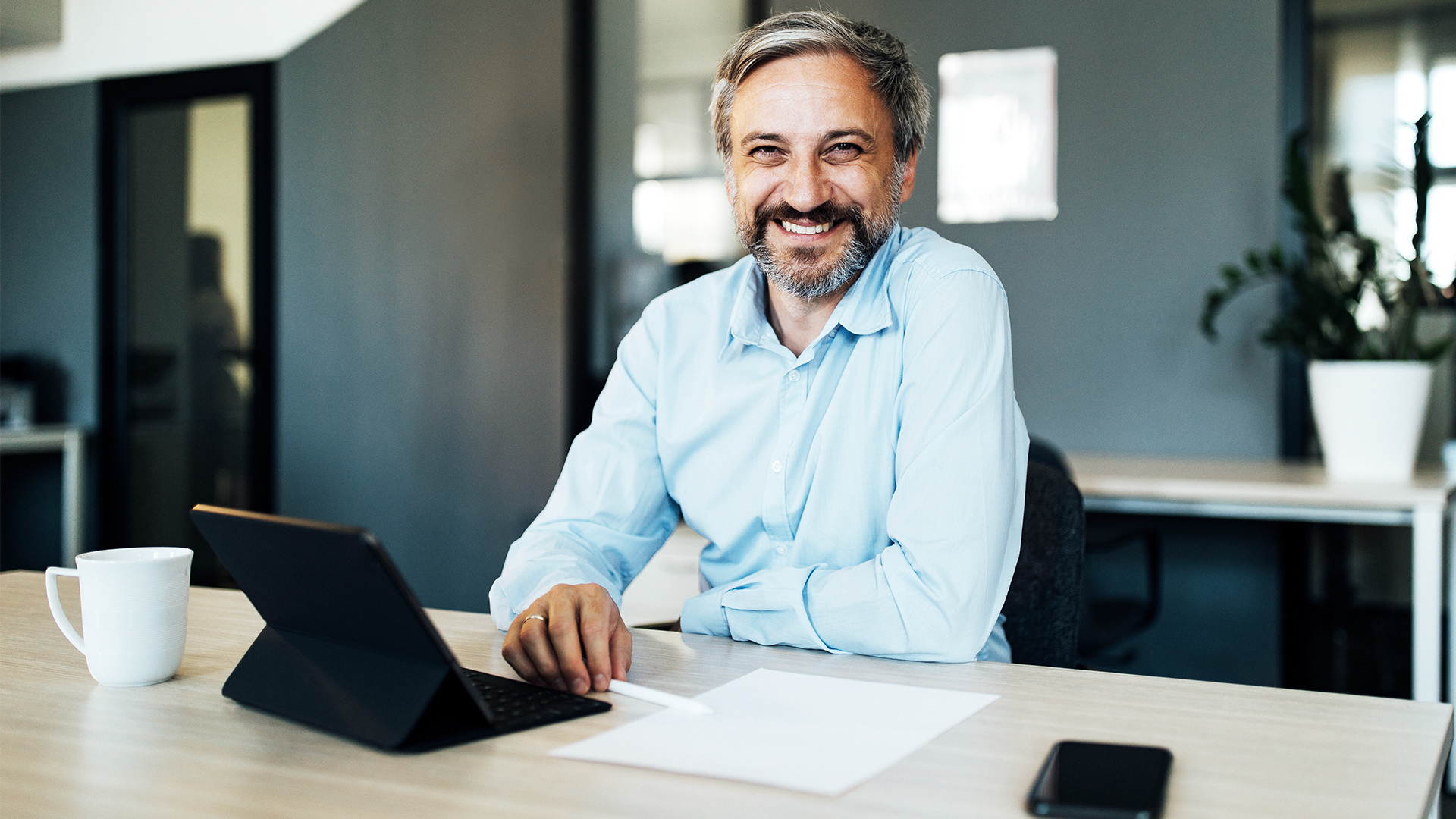 Man smiling at desk