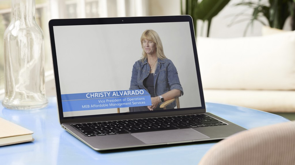 Christy Alvarado being interviewed, pictured on a laptop screen.