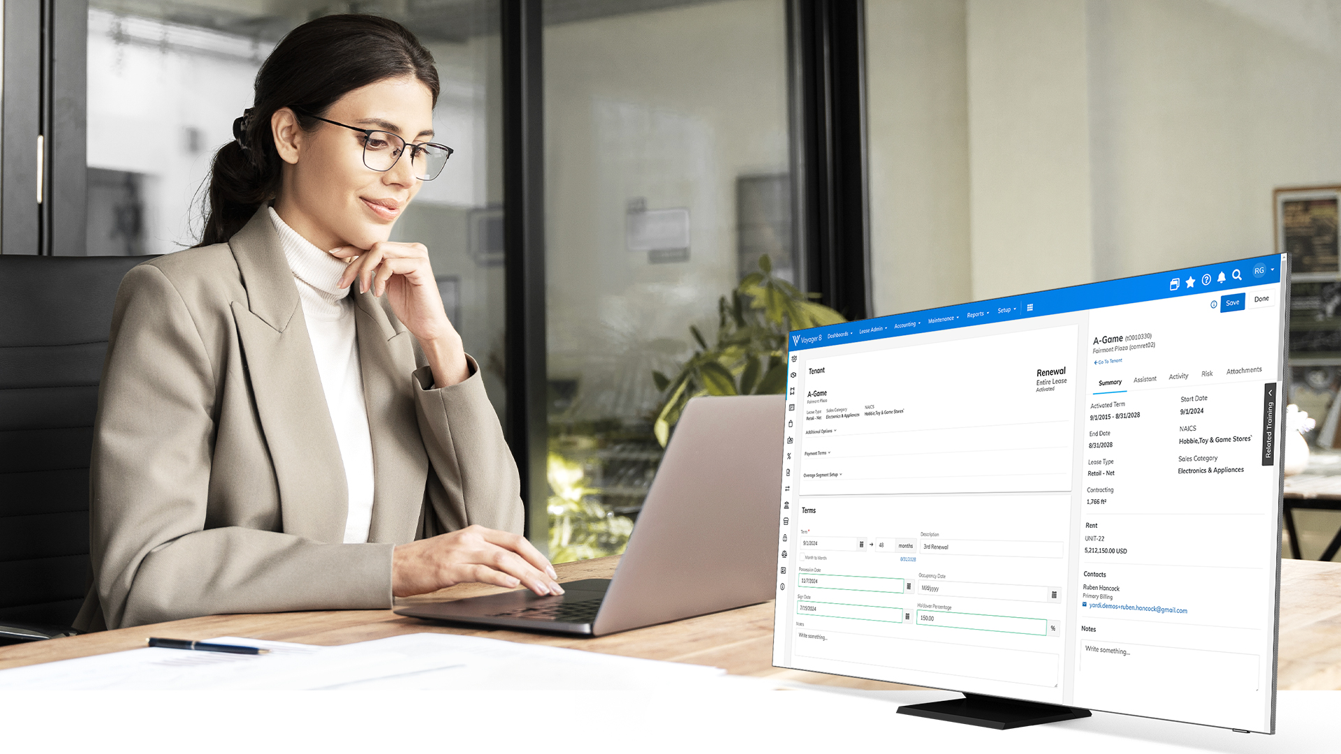 Woman at laptop showing Yardi software for lease management