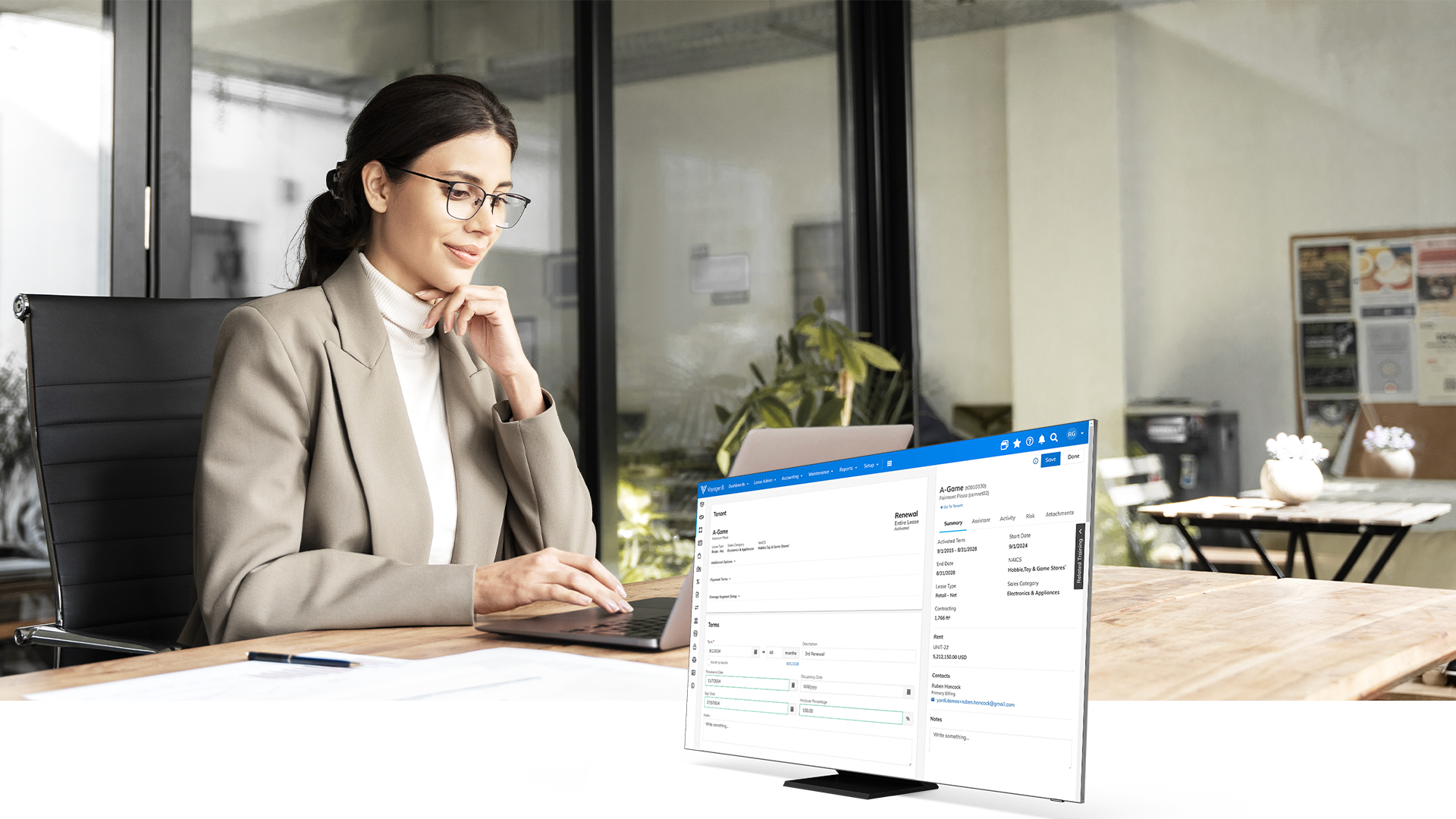 Woman at laptop showing Yardi software for lease management