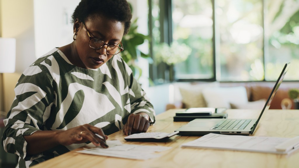 Woman at desk with laptop open