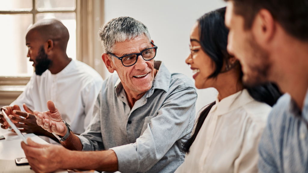 Senior professional sharing knowledge with younger employees