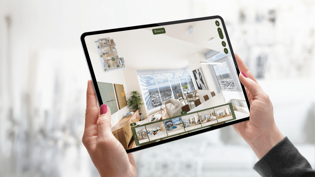 two hands holding a tablet displaying media for property marketing, including a 3D rendering of an apartment