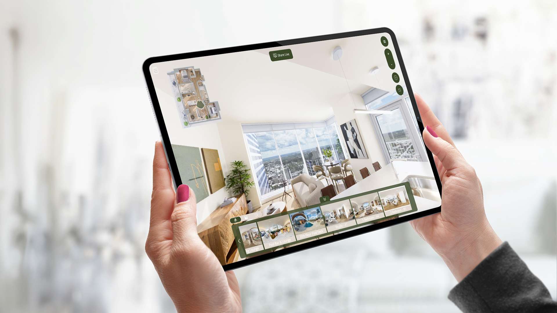two hands holding a tablet displaying media for property marketing, including a 3D rendering of an apartment