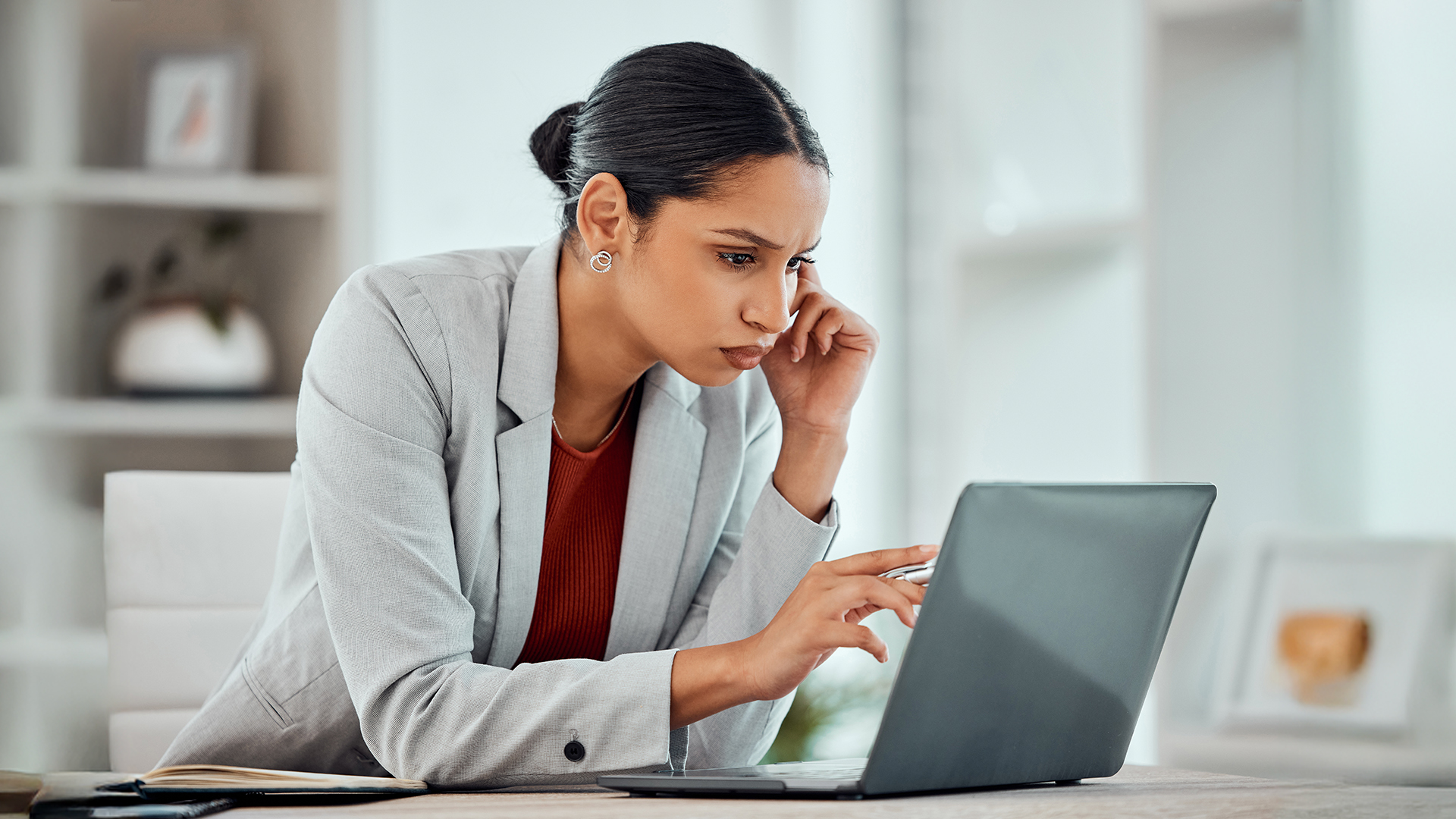 Woman looking sternly into laptop