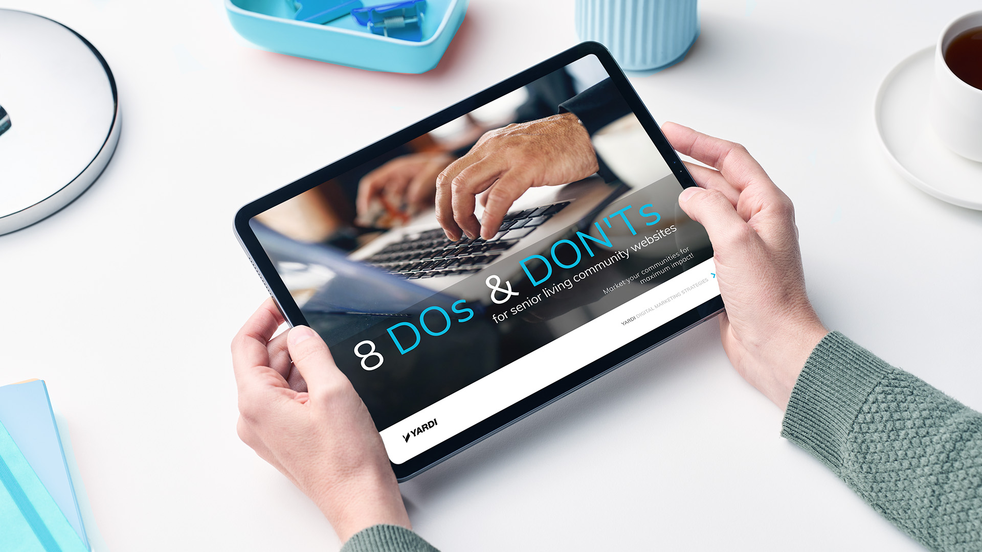 Hands holding an ebook titled "8 dos & don'ts for senior living community websites"