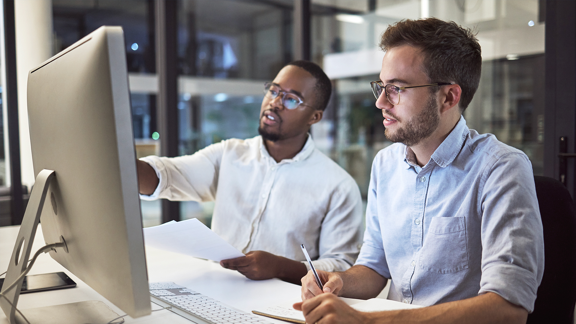 Two main looking happily at a computer screen