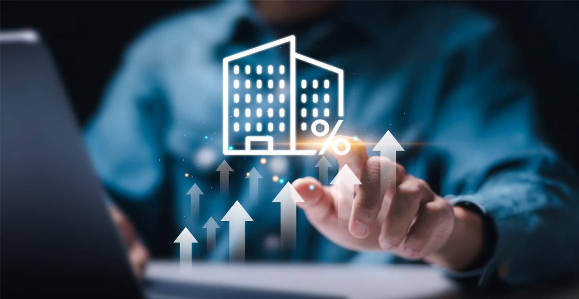 Building graphic hovering over a laptop with arrows symbolizing growth