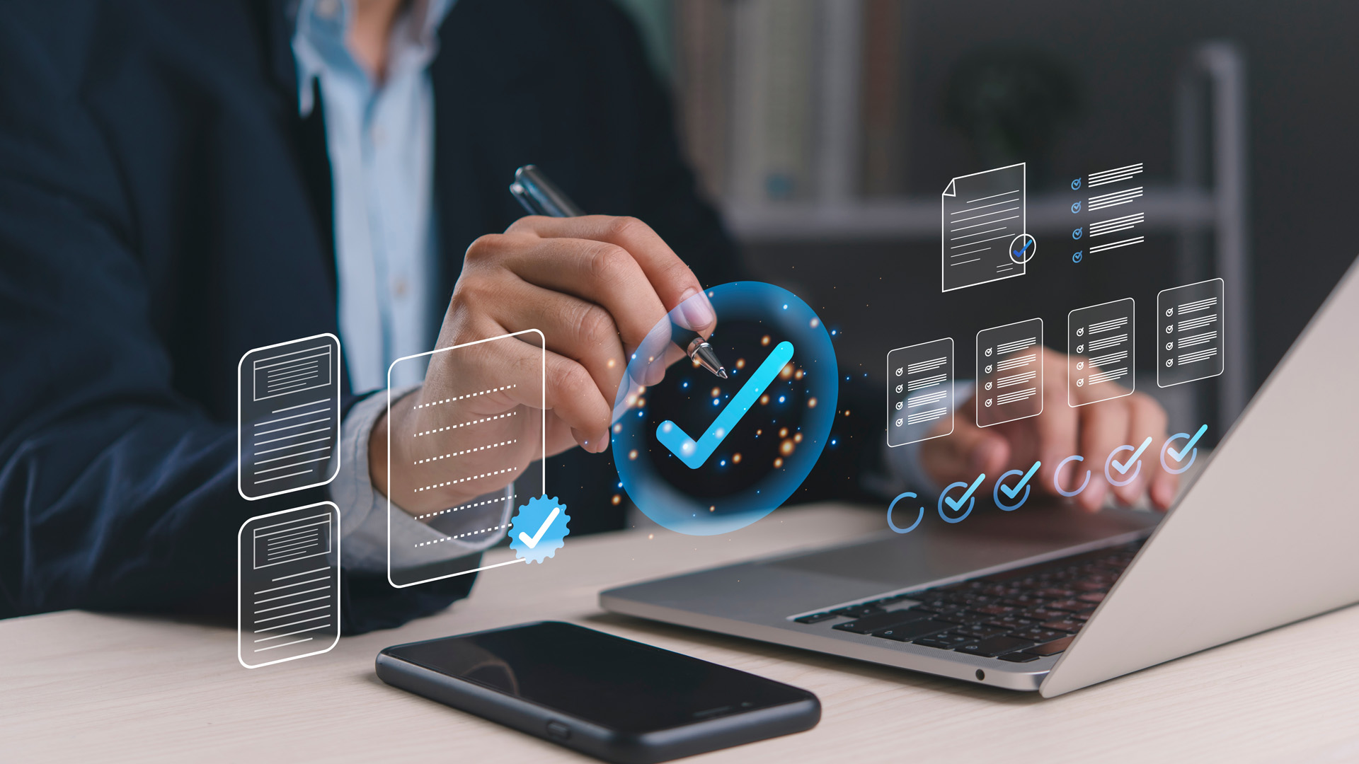 Many at laptop with holographic image of checkmark over his phone