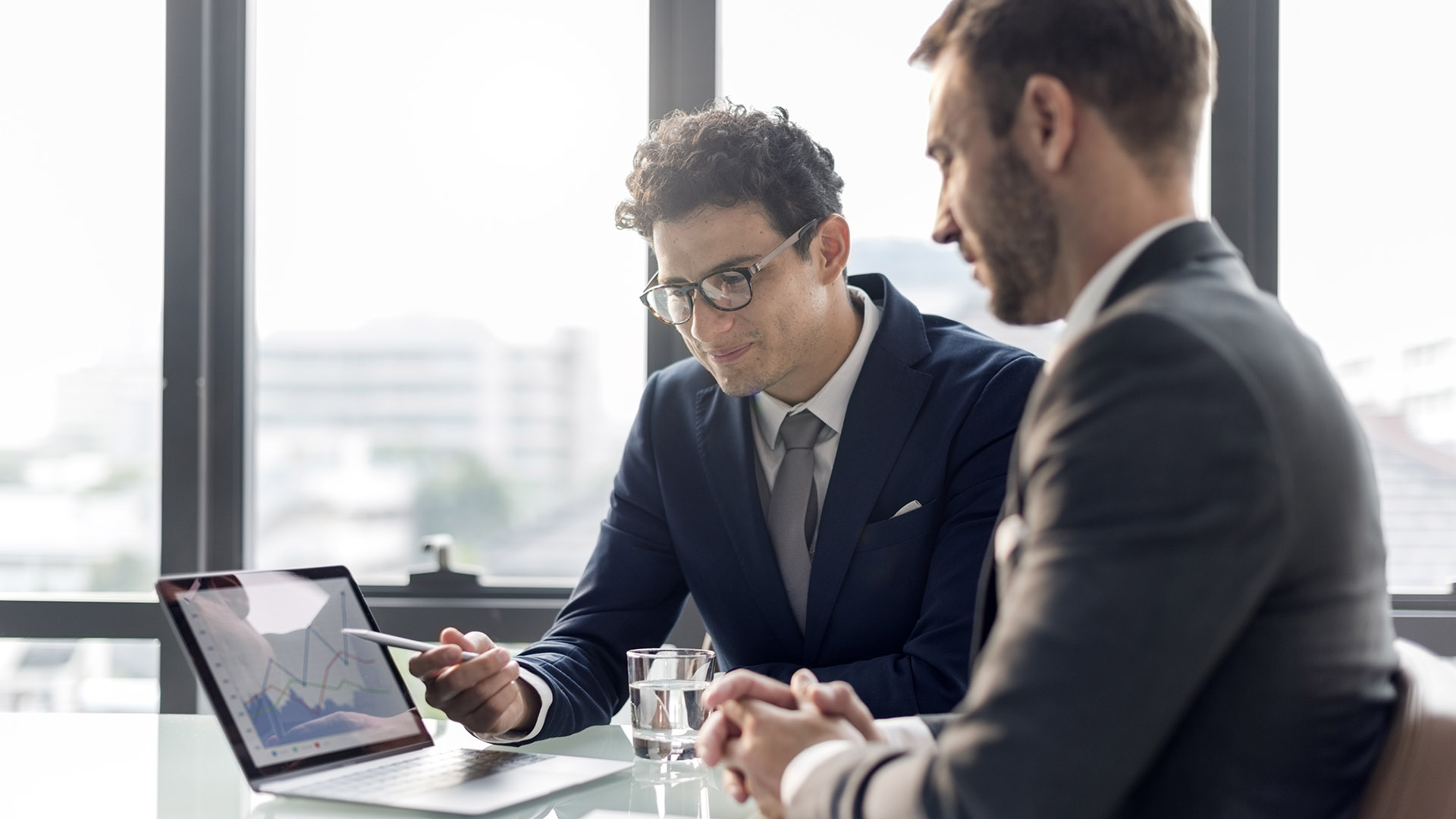 Two professionals looking at a laptop together