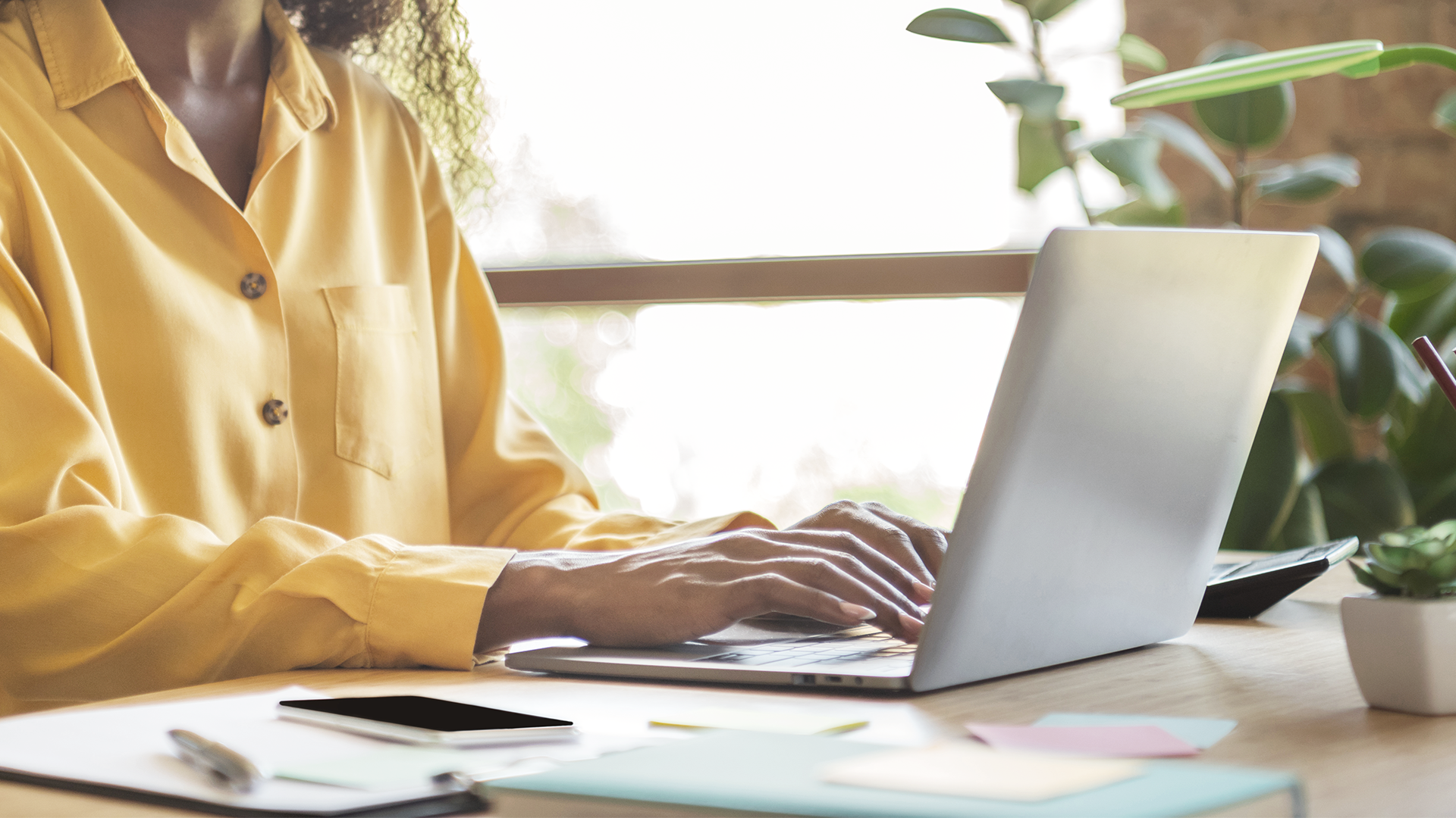 Person typing at laptop