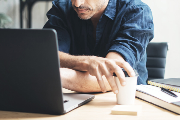 Man working on laptop at bright studio
