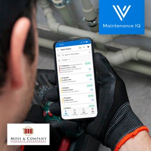Maintenance technician using the Maintenance IQ mobile app to manage work orders, with Moss & Company and Maintenance IQ logos displayed.