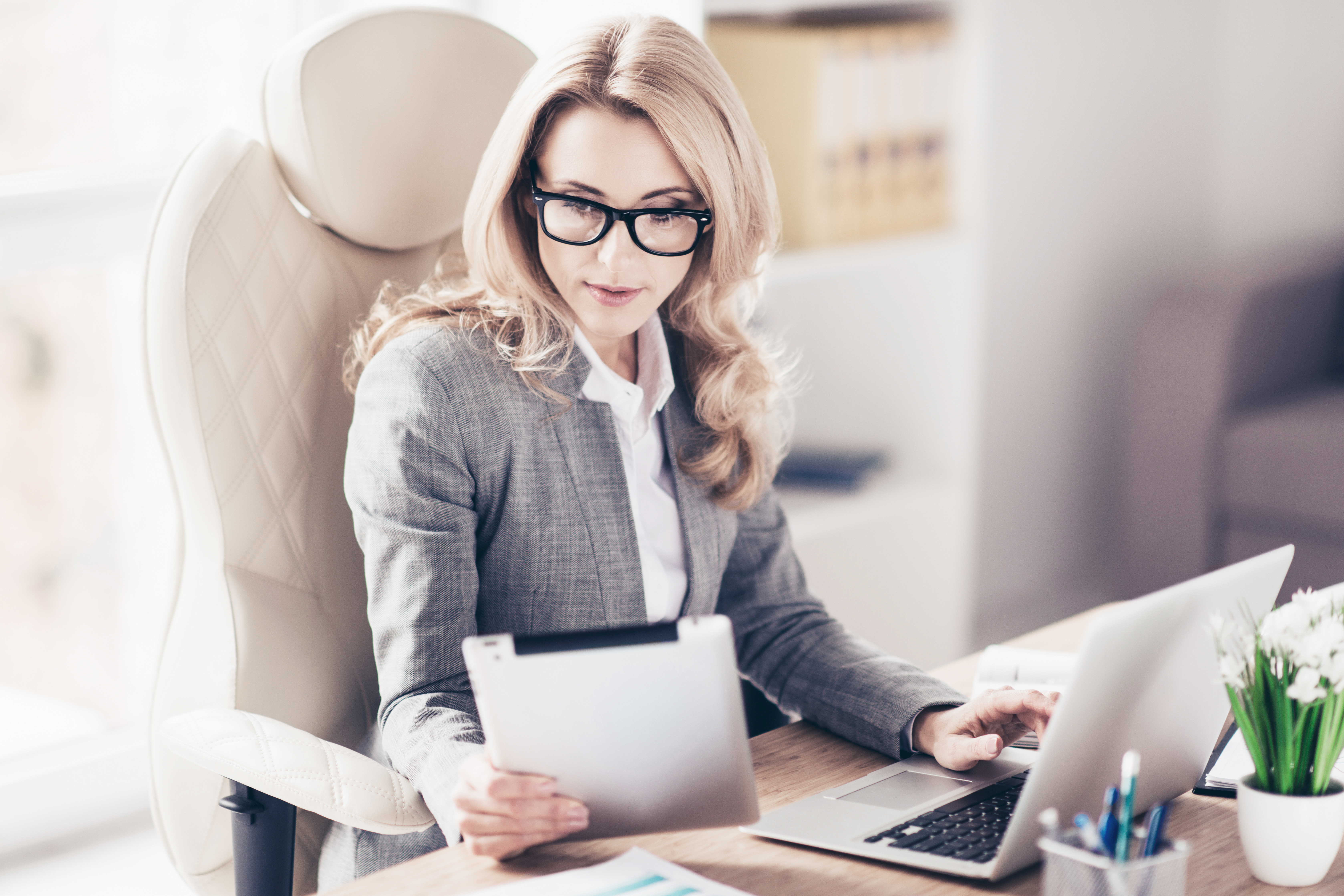 Pretty, charming, blonde woman using, browsing, typing, searchin