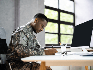Man in military uniform in office using Yardi Voyager Military