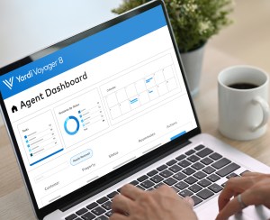 A person using Yardi Voyager property management software on a laptop