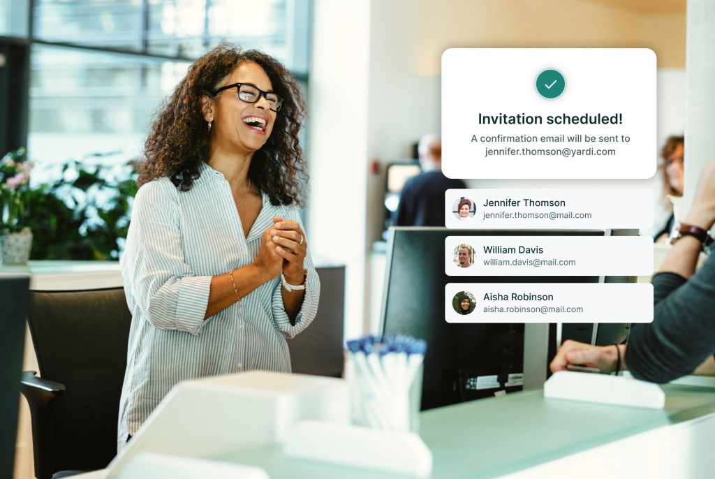 Smiling visitor at a reception desk beside a WorkCafe guest invitation confirmation and attendee list.
